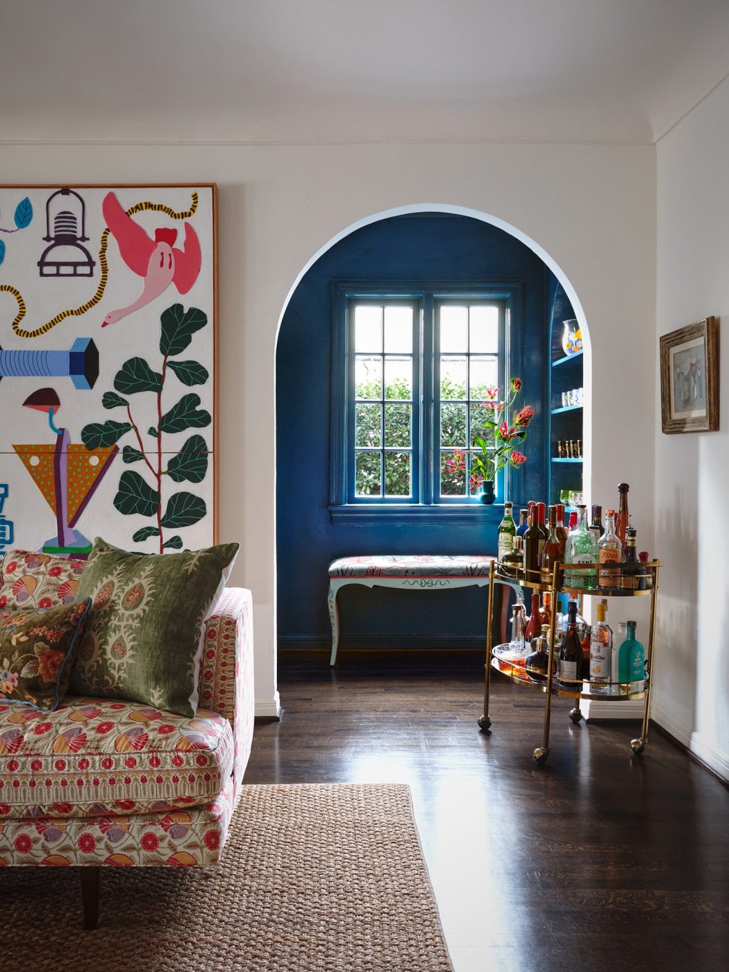 Corner of living room with view to blue-painted bar nook in a Spanish Colonial house in Highland PArk Village Dallas designed by Dafna Kikuchi of Daf&Co