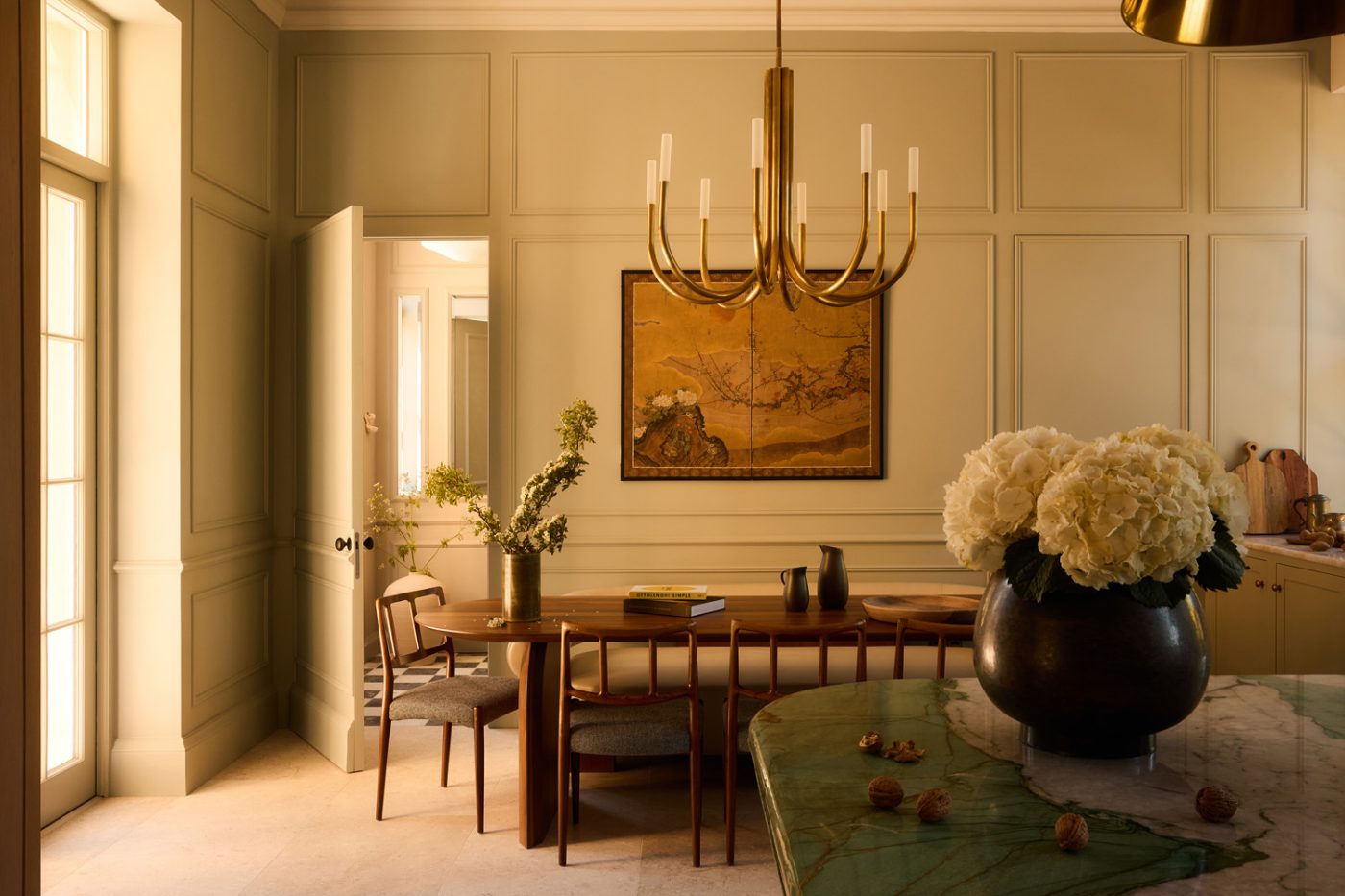Johannes Andersen chairs at contemporary oval table in dining area in kitchen of 19th-century Georgian-style manor house in Irish Countryside designed by Dublin-based Róisín Lafferty