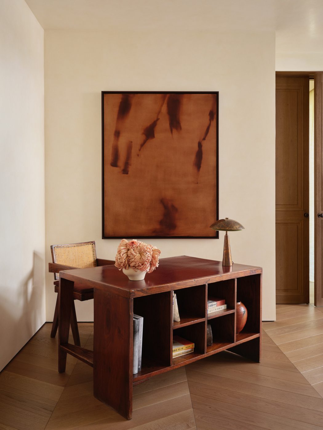vintage Pierre Jeanneret desk and chair in a corner of a primary bedroom of a Milan penthouse whose interiors are by Edo Mapelli Mozzi, founder of the design and development firm Banda.