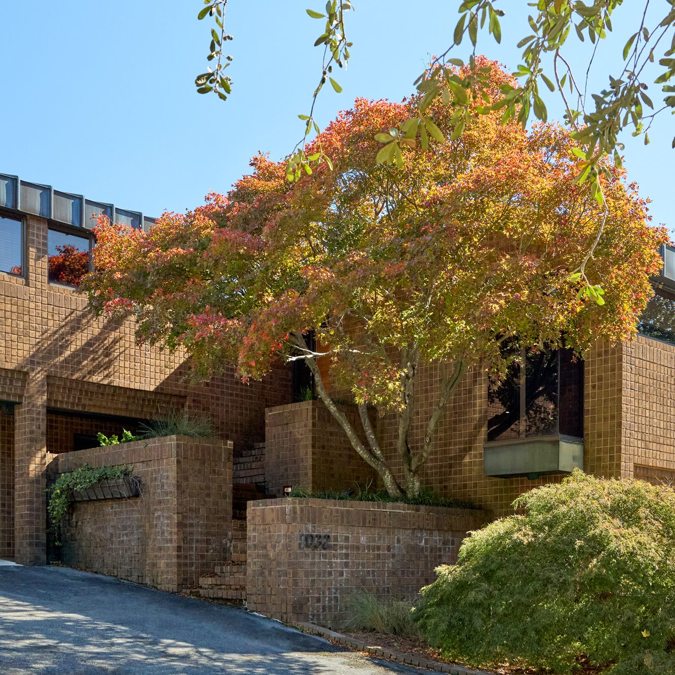 Exterior of the 1970s-era home in the Emeryville neighborhood of High Point North Carolina owned by Portrait of husband and wife Michael Radziewicz and Jennifer Ponce, of the mid-century-modern furniture gallery PRB Collection, originally designed by architect Frank Babcock