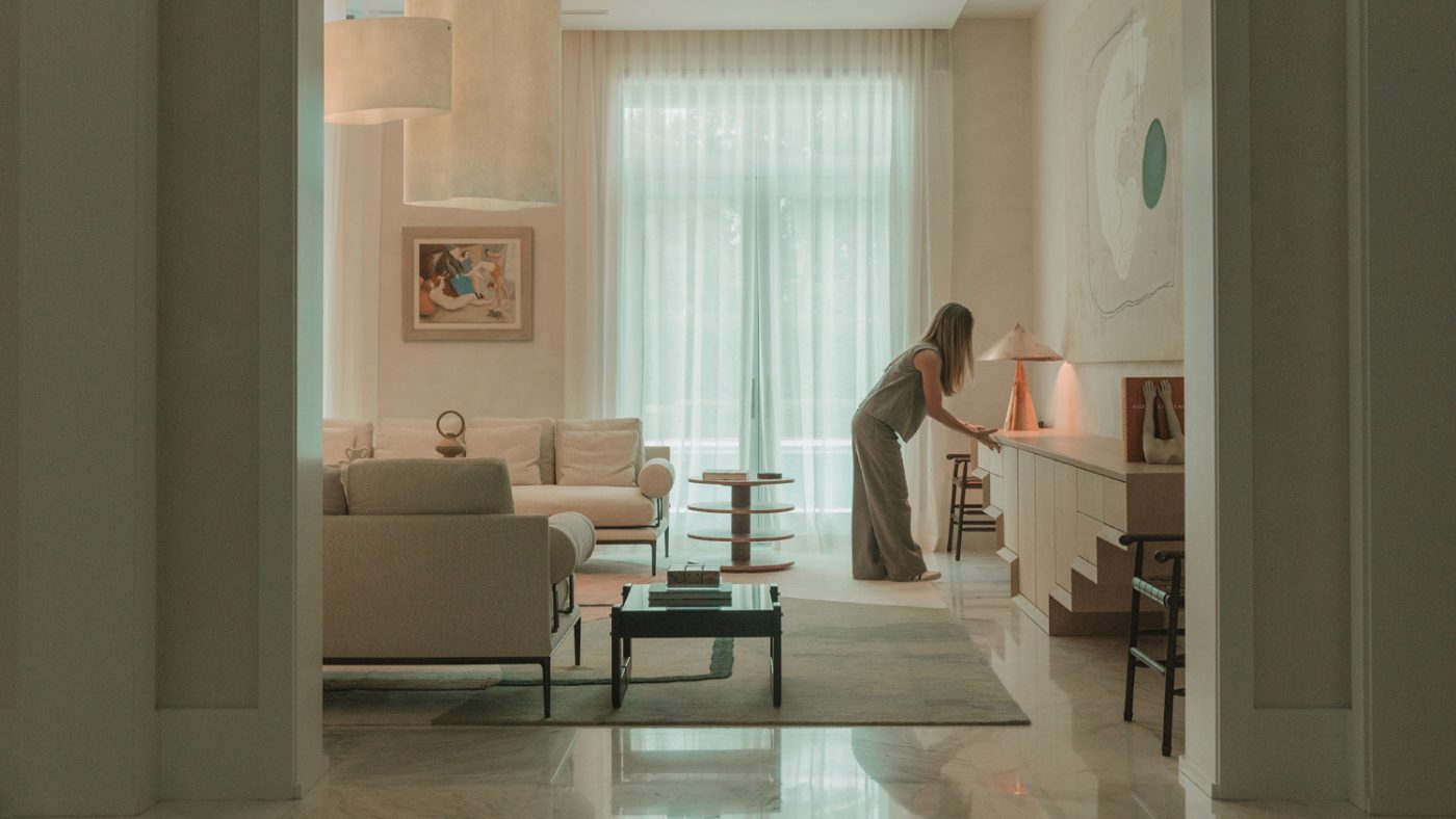 Designer Marcela Cure in a home she designed in Miami with polished sone floors and a light colored off-white color scheme