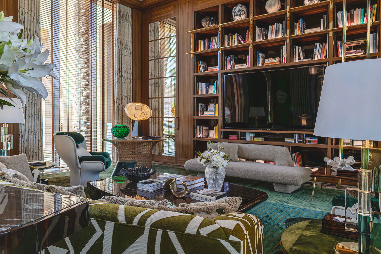 A Lalique vase atop an Oitoemponto-designed coffee table, a Mauro Fabbro lamp, Marzio Cecchi table in the game room of the entertaining pavilion on a large compound in Saudi Arabia by Jacques Bec and Artur Miranda's architecture and design studio Oitoemponto