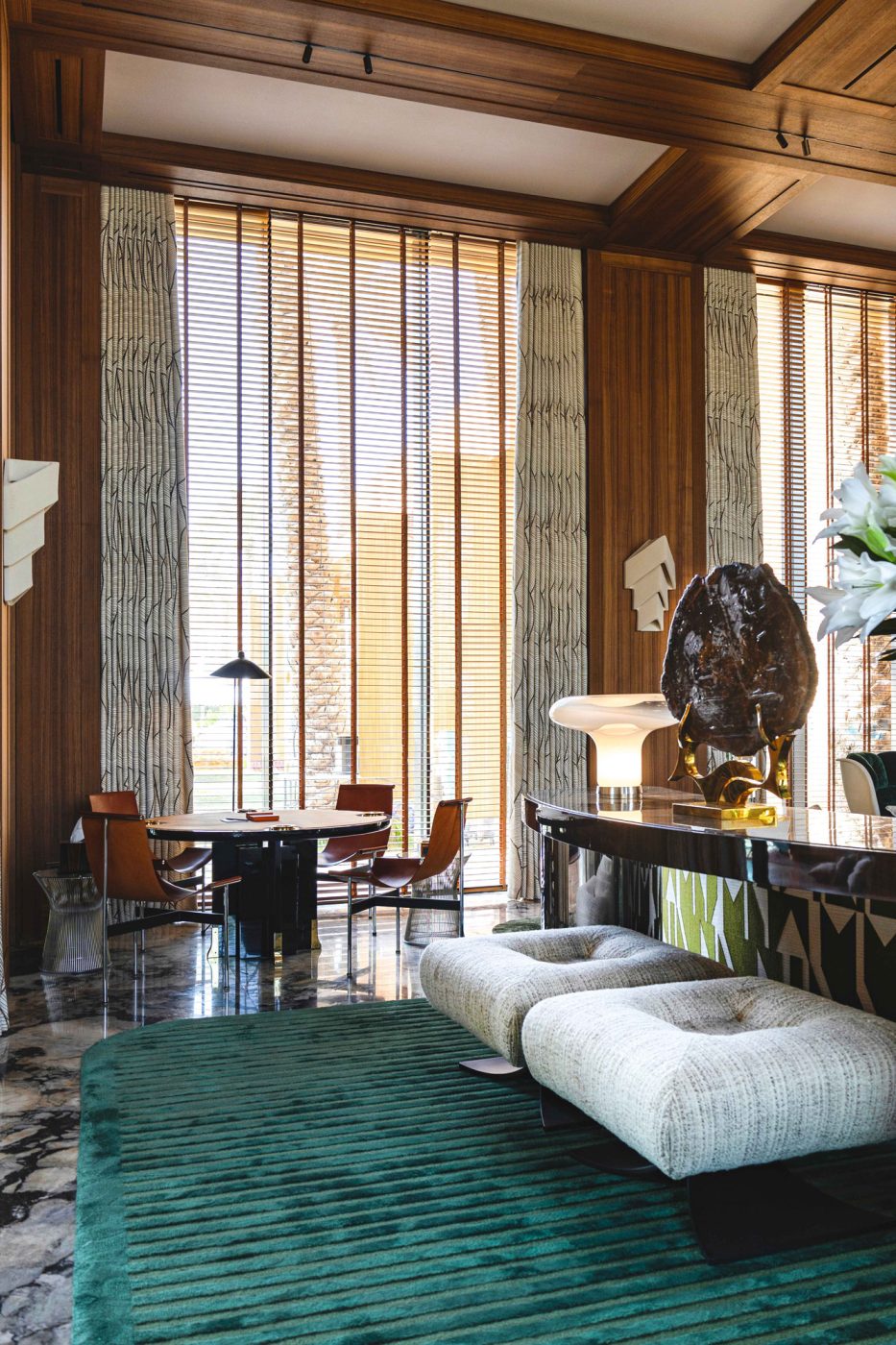 Katavolos, Kelley & Littell chairs from Andreas Schneider at a table near the Oscar Niemeyer stools behind the couch in the game room of the entertaining pavilion on a large compound in Saudi Arabia by Jacques Bec and Artur Miranda's architecture and design studio Oitoemponto
