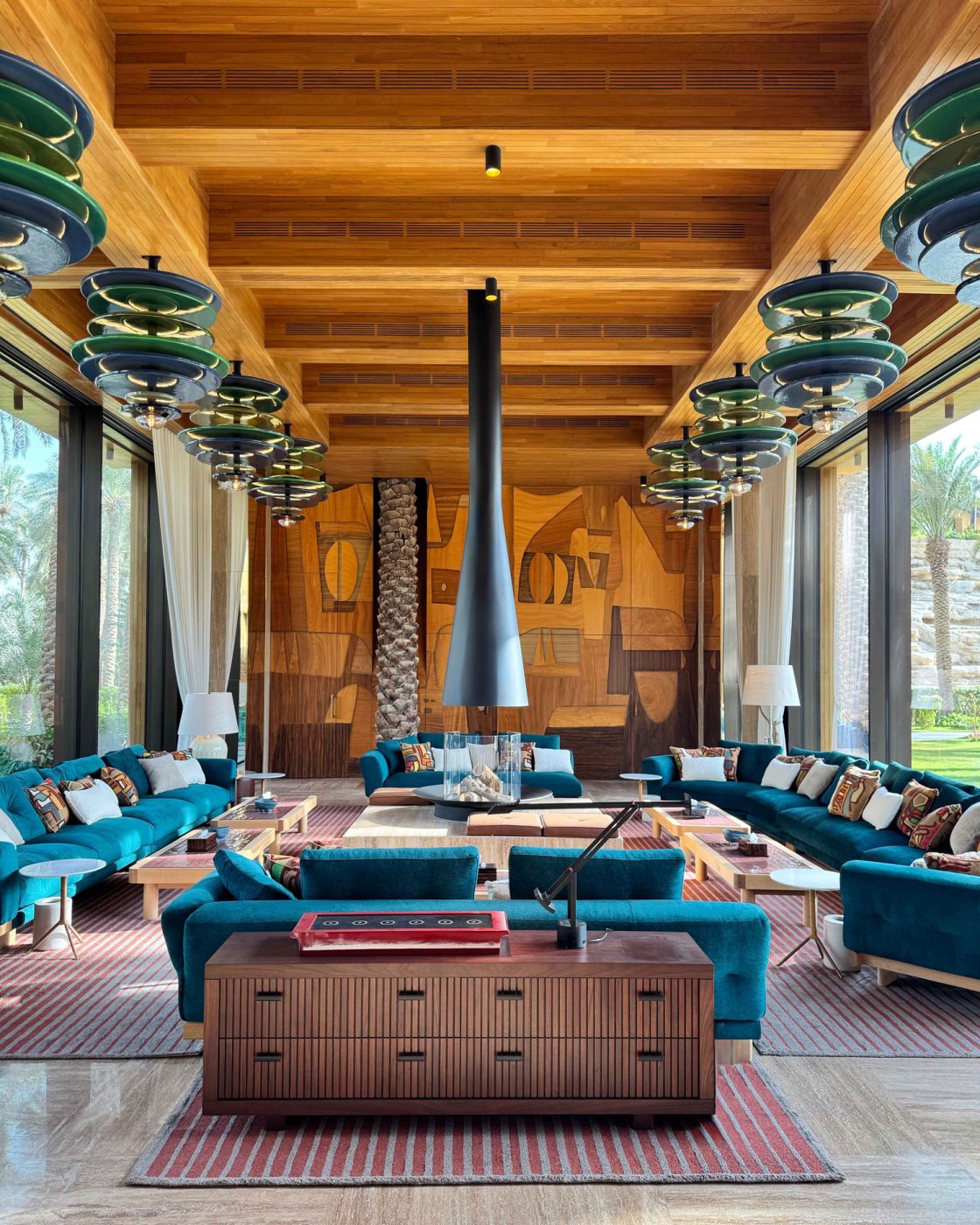 Patricia Urquiola sofas, Jonathan Amar side table and Nestor Rotsen ceiling lights in the diwaniyah sitting room of the entertaining pavilion on a large compound in Saudi Arabia by Jacques Bec and Artur Miranda's architecture and design studio Oitoemponto
