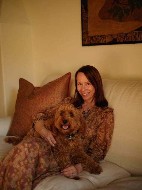 Los Angeles-based interior designer Sarah Shetter posed on sofa with her dog