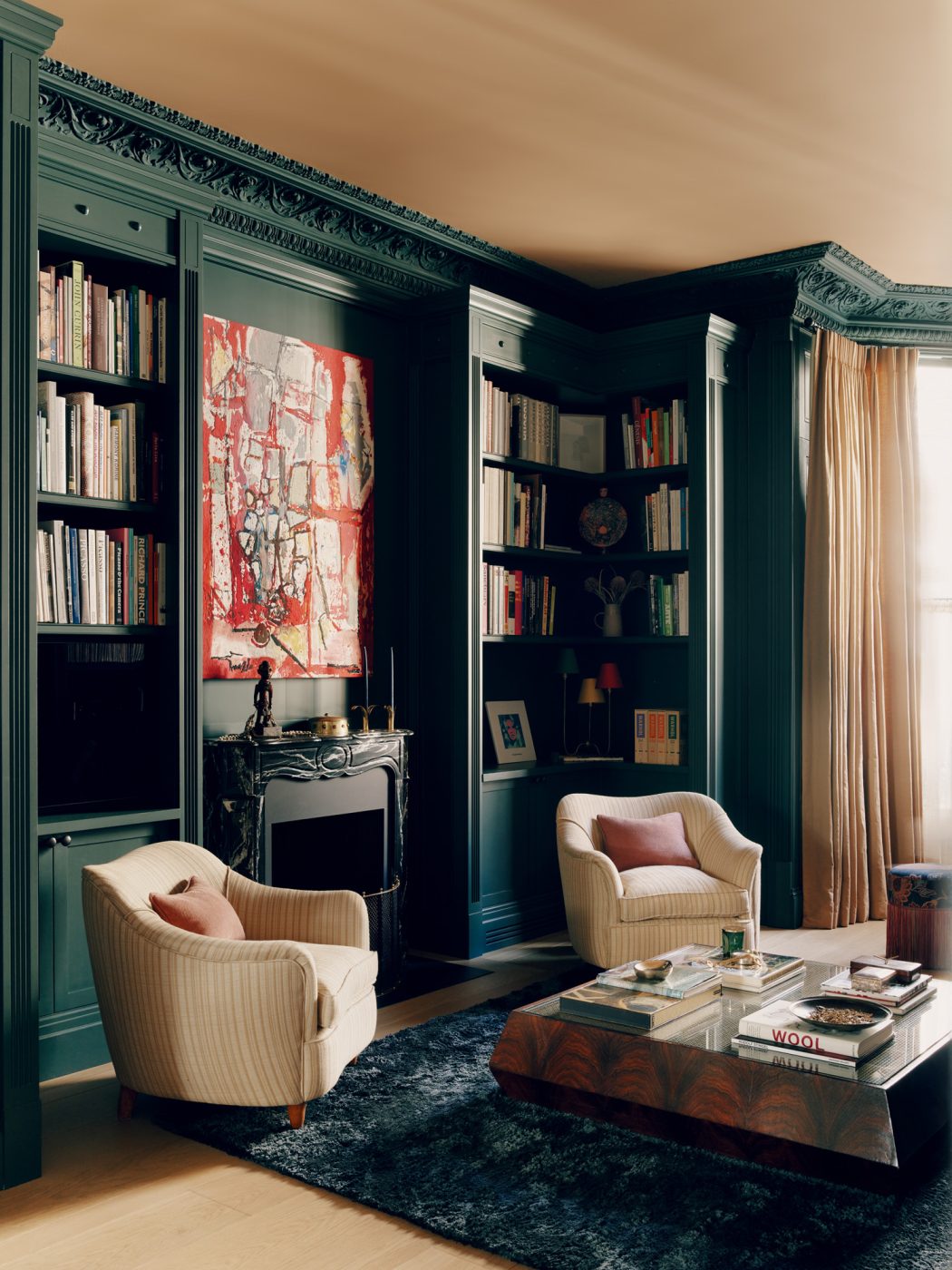 Library of a Victorian townhouse in London's Holland Park designed by the studio De Rosee Sa and featuring Gio Ponti for Casa e Giardino armchairs and Ivan Morley artwork over the mantel