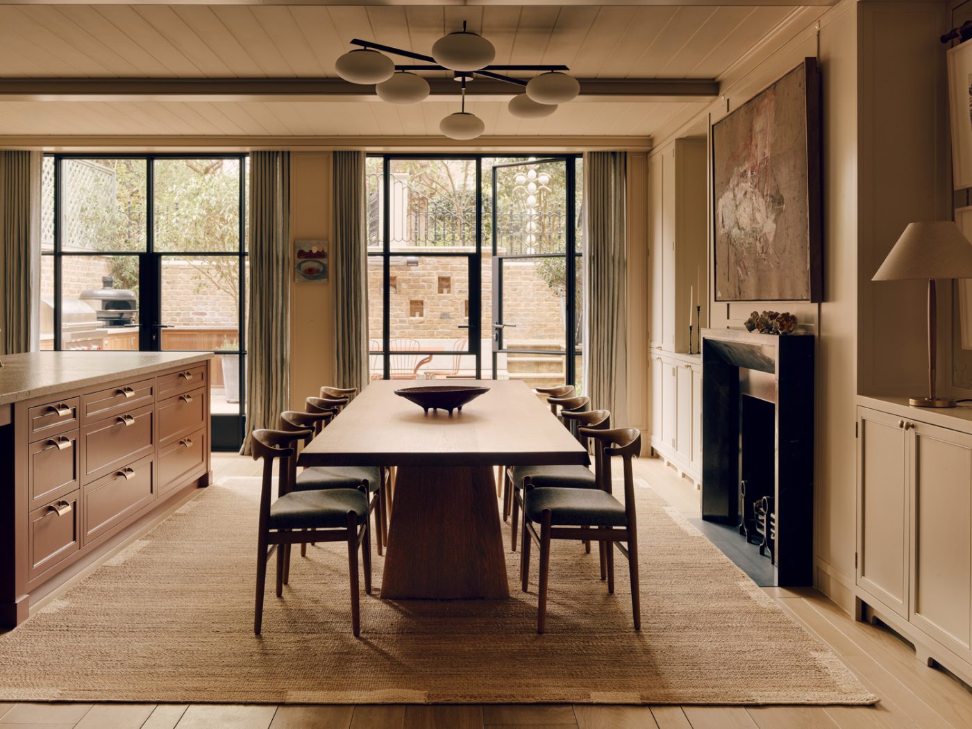 Dining area of the kitchen of a Victorian townhouse in London's Holland Park designed by the studio De Rosee Sa and featuring cow horn chairs and table are all by Hans Wegner plus a Sei Lune fixture, by Angelo Lelii for Arredoluce, from soyun k.