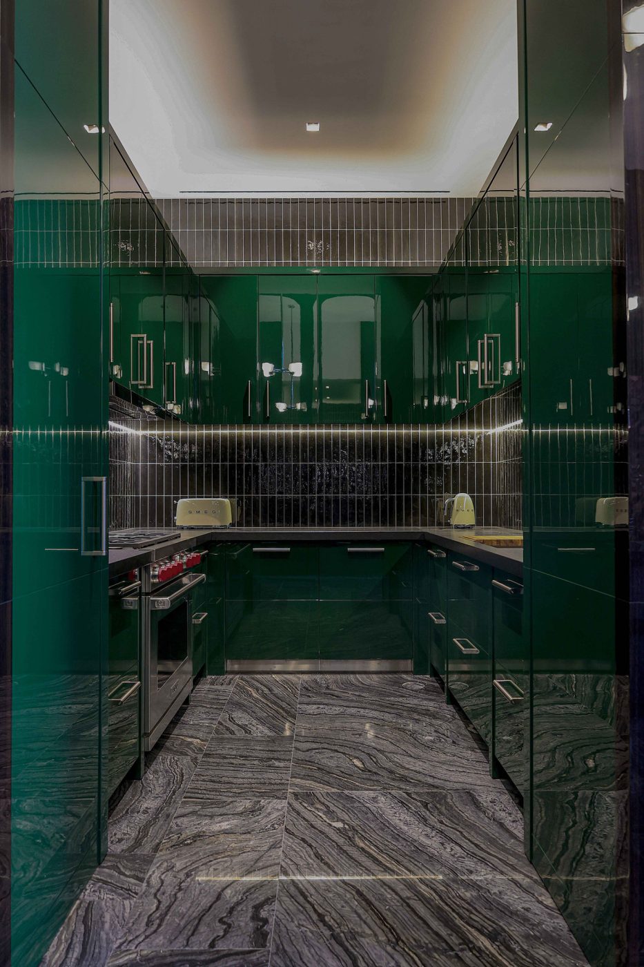 lacquered green-painted cabinets in the kitchen of the entertaining pavilion on a large compound in Saudi Arabia by Jacques Bec and Artur Miranda's architecture and design studio Oitoemponto