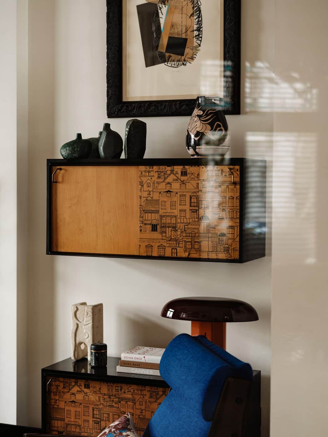 Robert Heritage wall-mounted cabinets and Gustavo Pulitzer Finali chair in the front sitting room in the apartment in London's Kensington owned and decorated by Romanos Brihi, co-founder of the London interior design firm Studio Vero