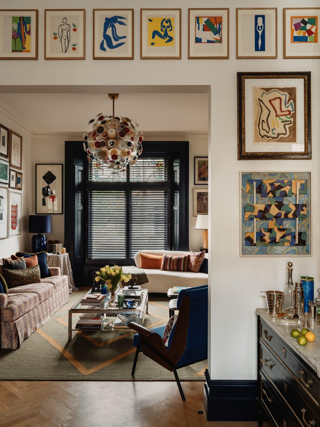 View from the rear to the front sitting room in the apartment in London's Kensington owned and decorated by Romanos Brihi, co-founder of the London interior design firm Studio Vero