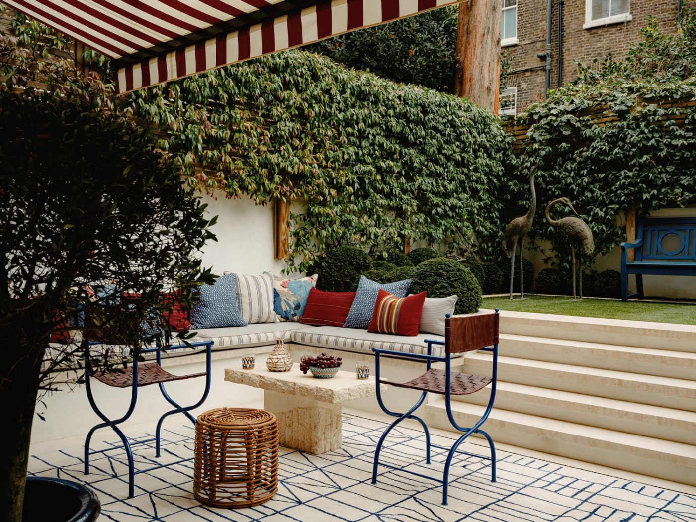 Outdoor garden with sunken patio in the apartment in London's Kensington owned and decorated by Romanos Brihi, co-founder of the London interior design firm Studio Vero