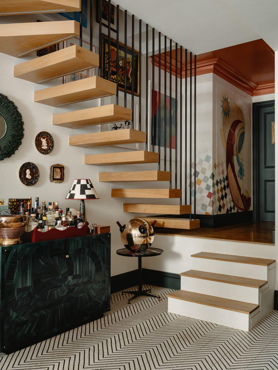 Staircase into lower level kitchen and dining area in the apartment in London's Kensington owned and decorated by Romanos Brihi, co-founder of the London interior design firm Studio Vero