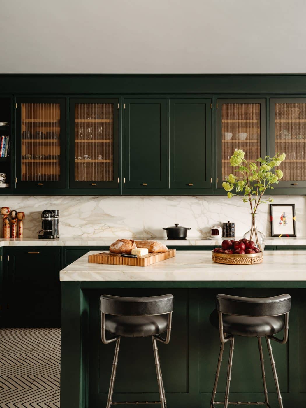 Kitchen with green-painted cabinets in the front sitting room in the apartment in London's Kensington owned and decorated by Romanos Brihi, co-founder of the London interior design firm Studio Vero