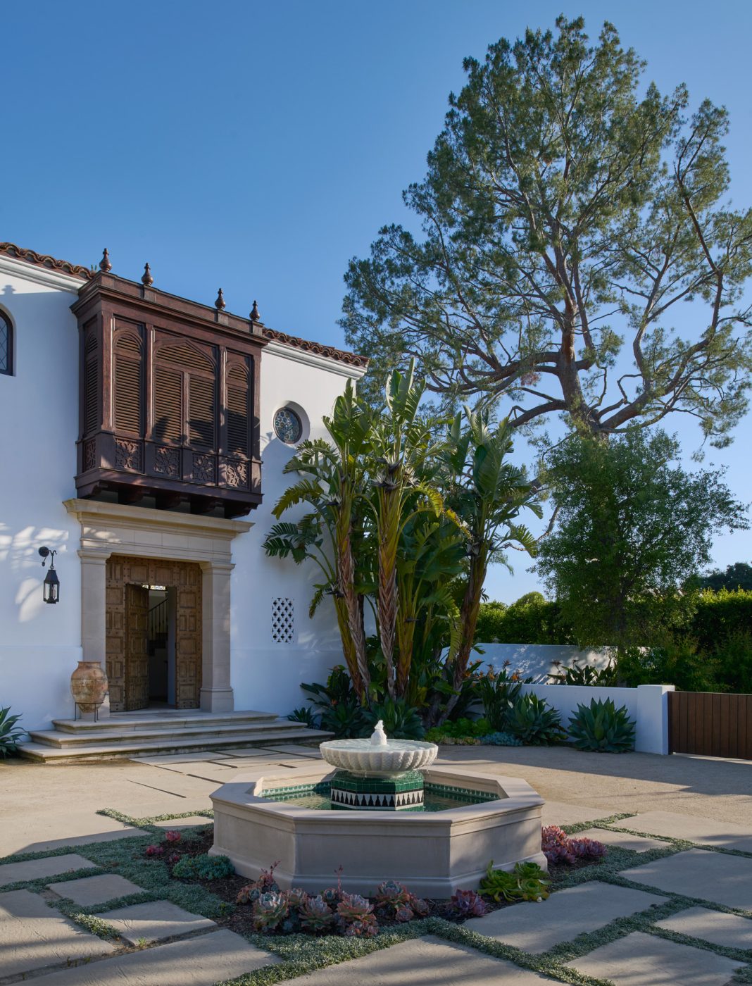 Fountain and front courtyard in a California Spanish Revival house by Ohara Davies-Gaetano and Michael G. Imber