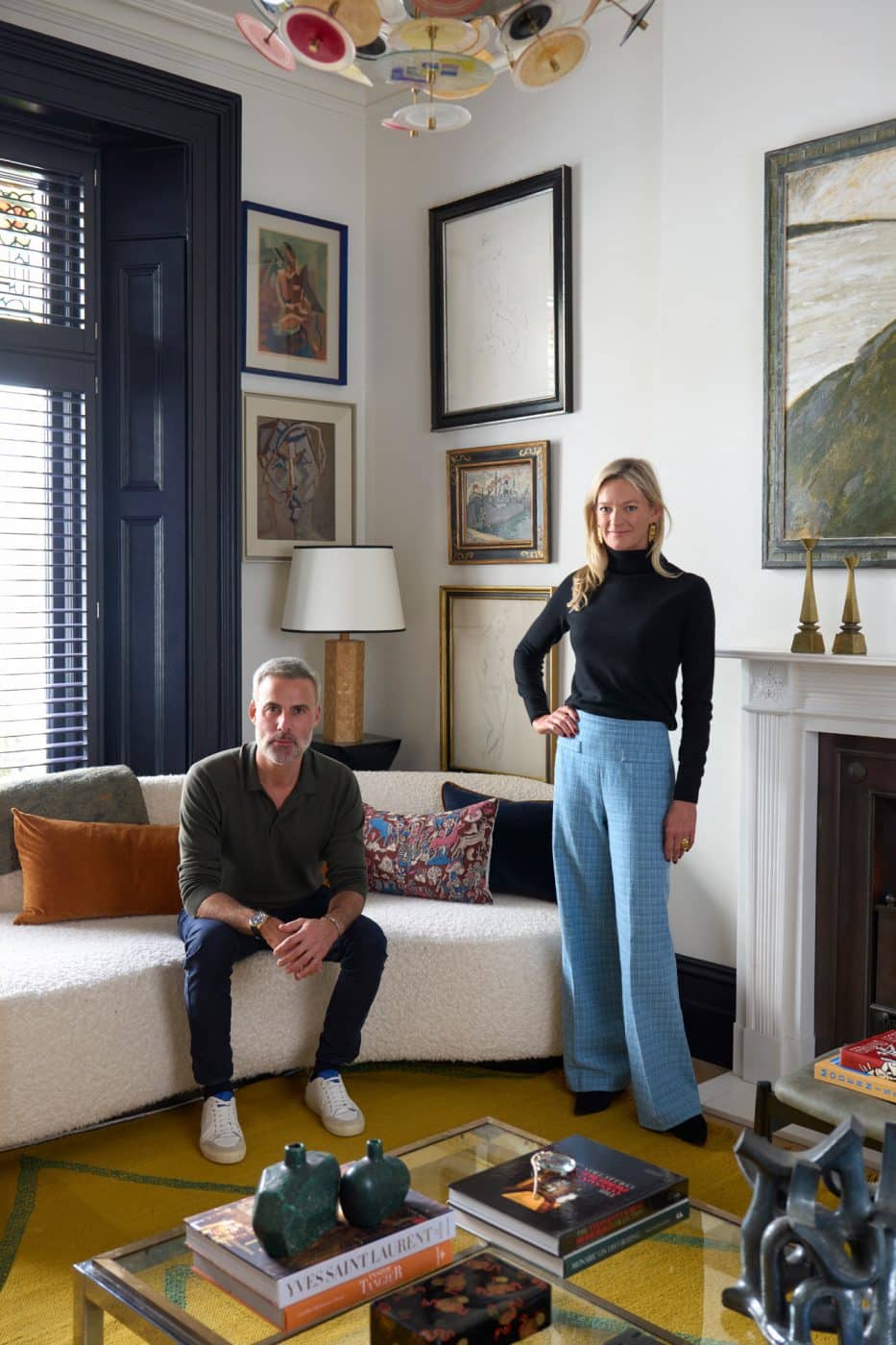 Portrait of interior design firm Studio Vero founders Romanos Brihi and Venetia Rudebeck in the front sitting room of Brihi's own apartment in London's Kensington