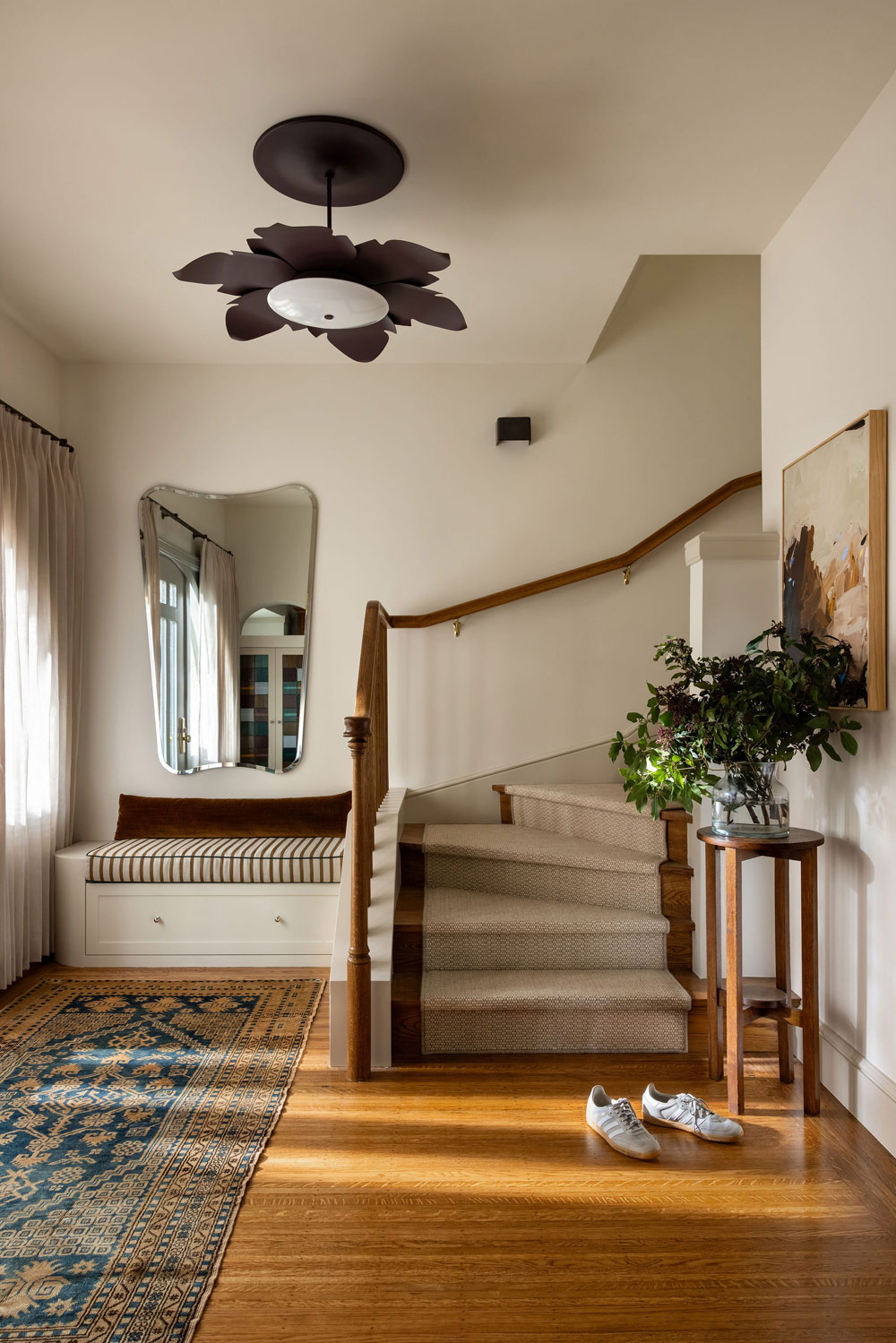 Foyer of Craftsman-style house in San Francisco's Presidio designed by Katie Troutman and featuring a mirror from Alguacil & Perkoff Ltd. and lighting from Urban Electric