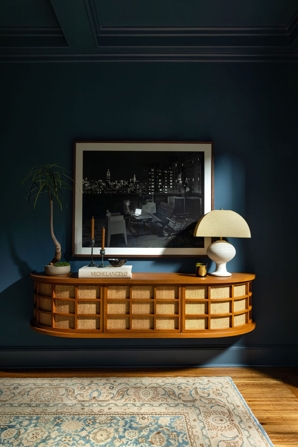 Dining room of Craftsman-style house in San Francisco's Presidio designed by Katie Troutman and featuring a large-format black-and-white Matthew Pillsbury photograph of Manhattan hung over a wall-mounted Sweetbriar credenza by West Haddon Hall.