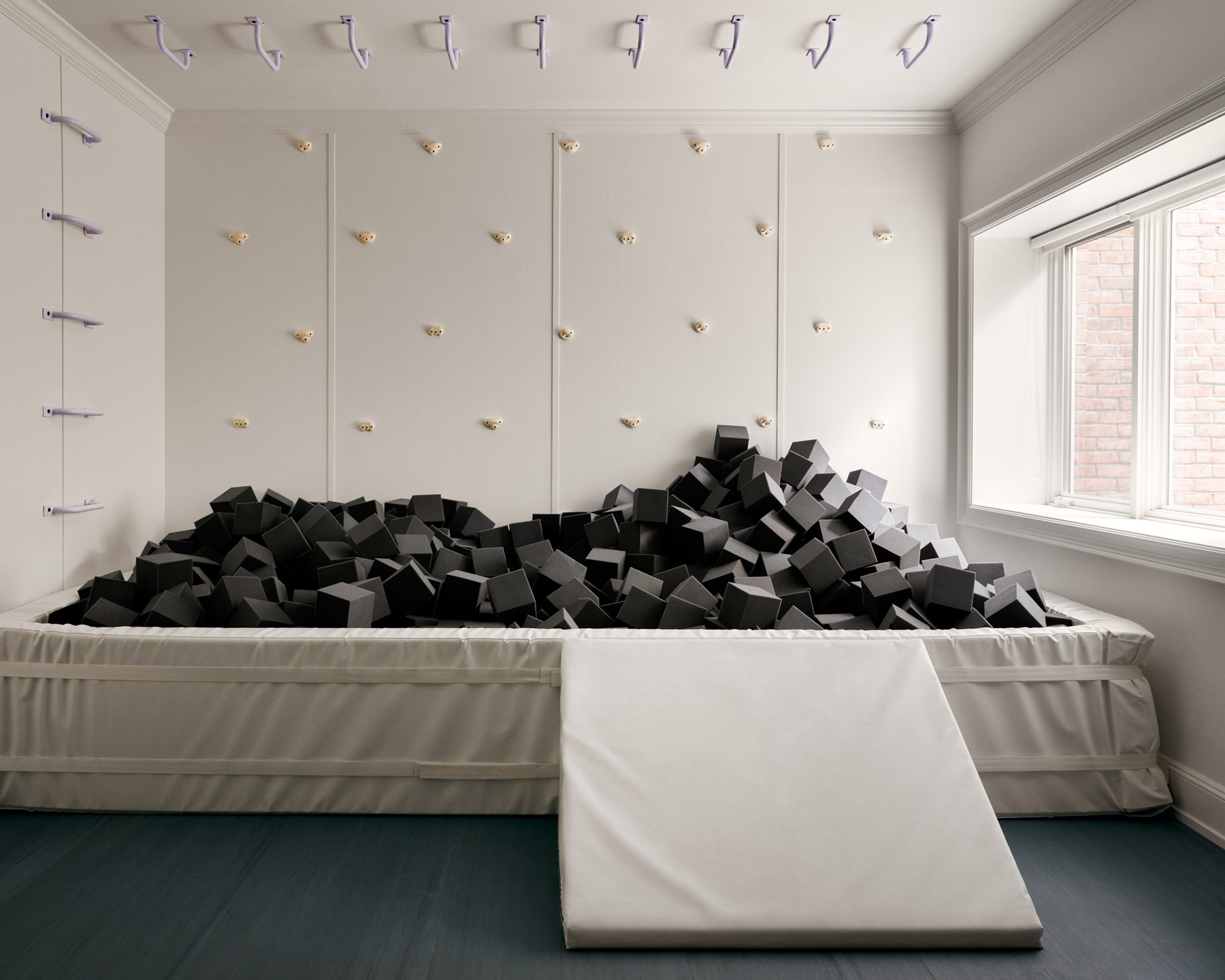 Foam pid in play area on lower level of Southampton house with interiors by Janine Carendi MacMurray or Area Interior Design