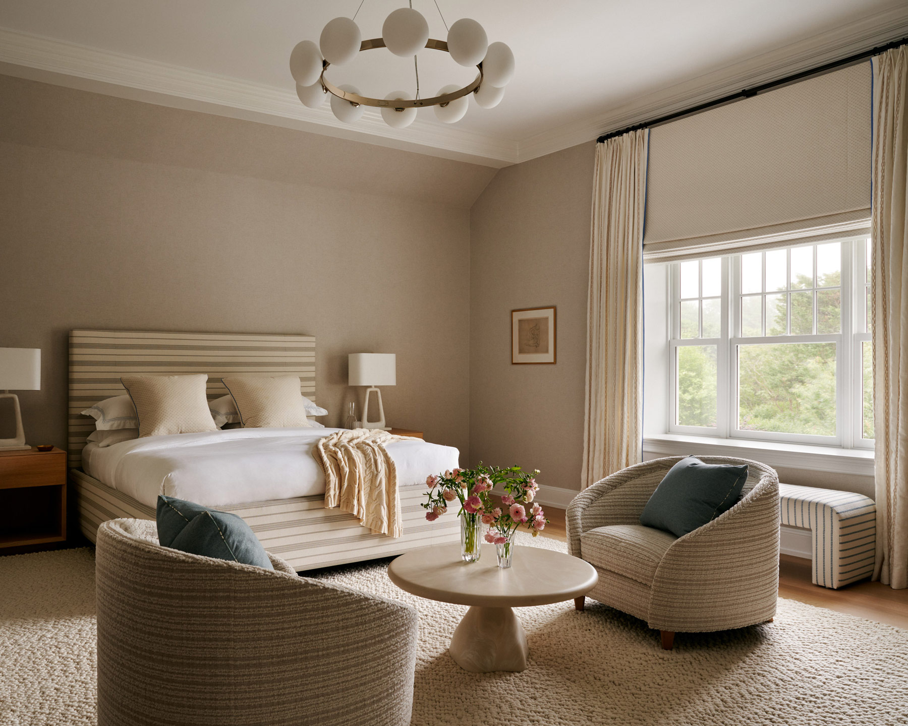 primary bedroom defined by neutral hues, expressed in a mix of custom and contemporary pieces and rich mix of textures in Southampton house with interiors by Janine Carendi MacMurray or Area Interior Design