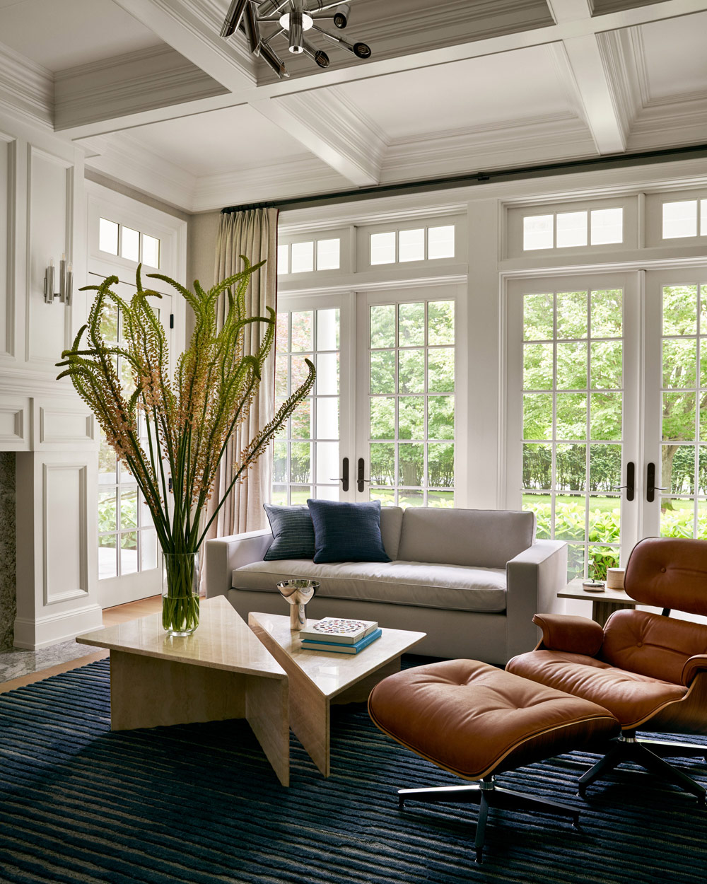 Eames lounge chair in sitting room of Southampton house with interiors by Janine Carendi MacMurray or Area Interior Design