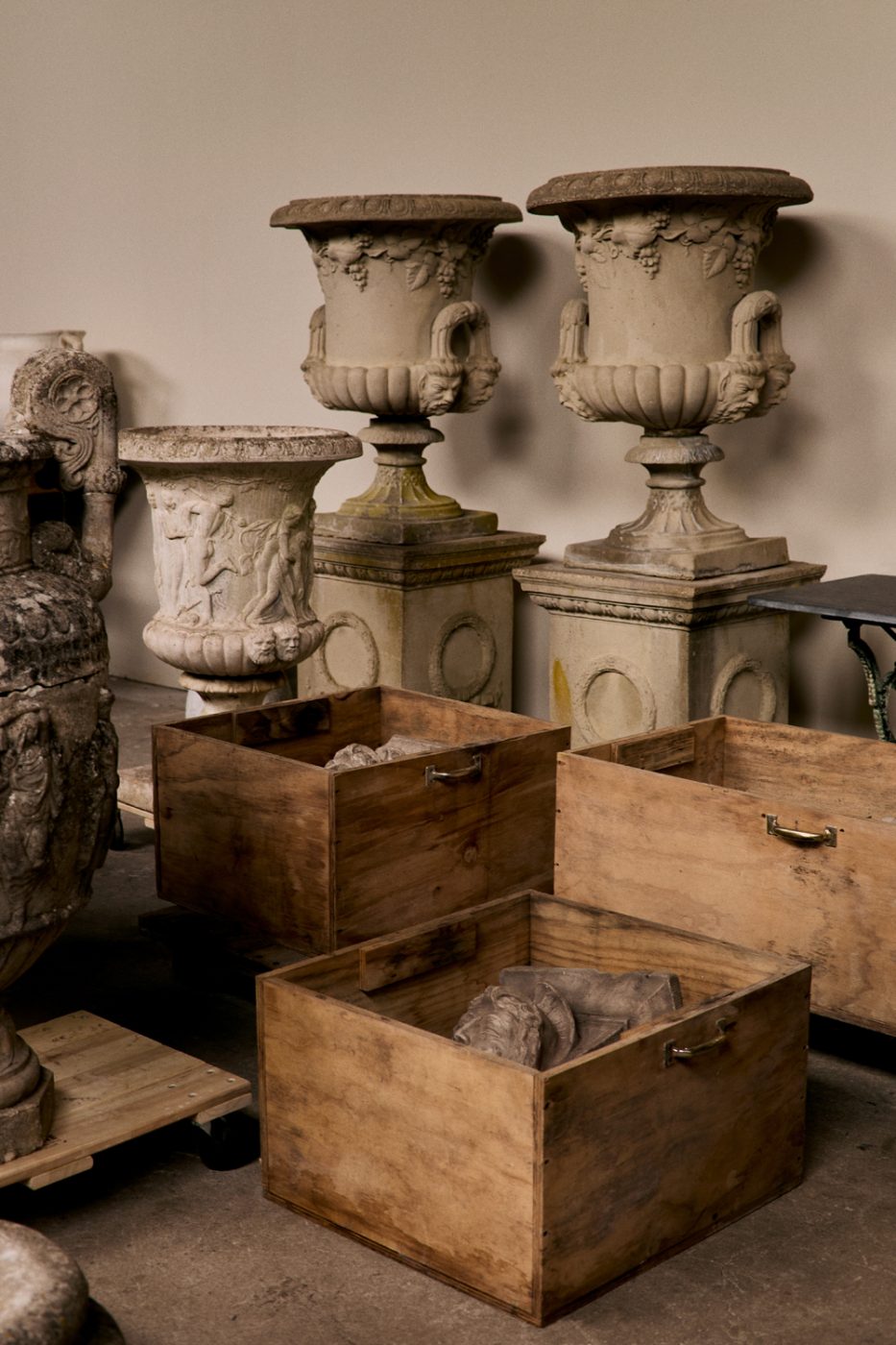 On offer by the gallery Galerie Green are urns including one from the 1950s cast with a relief in the style of an ancient Greco-Roman frieze and a nearly six-foot-tall pair, with pedestals, decorated with a grape-leaf design