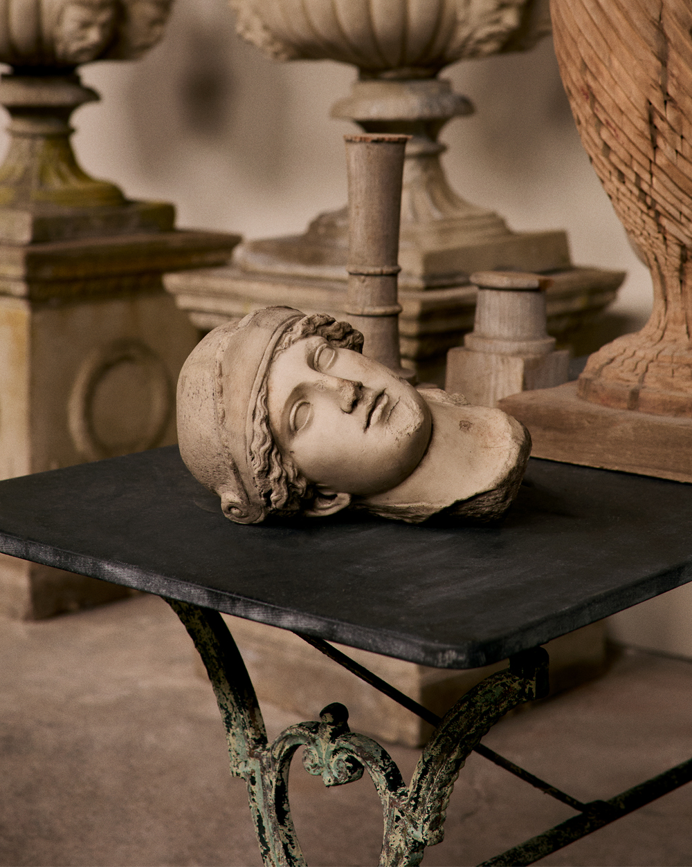 On offer by the gallery Galerie Green are a bust, cast in resin and inspired by antiquity and a bluestone-topped scroll-leg table