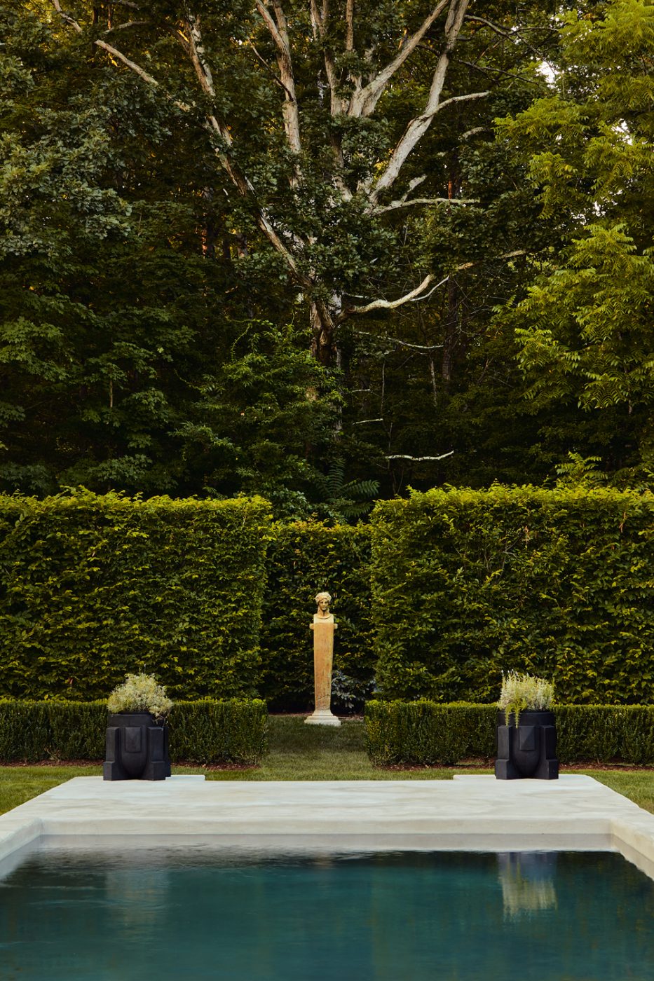 Pool, patio and high hedges at the of Rhinebeck New York Home of Matthew and Casey Fisher, whose landscapes were designed by the Brooklyn studio Harrison Green.
