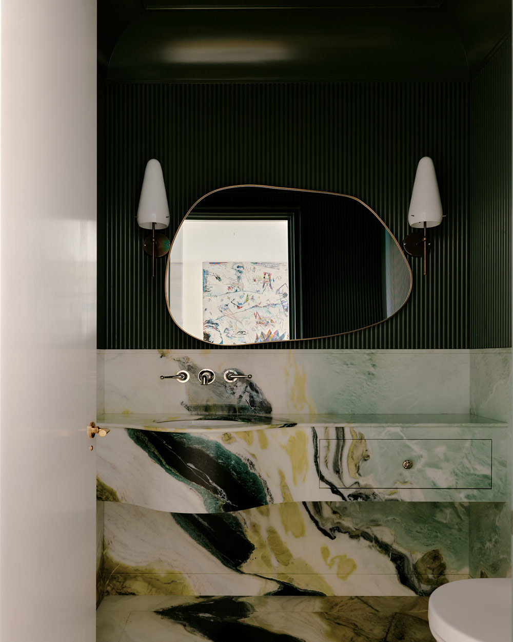 Green ridged walls over green mable vanity in the powder room of a duplex apartment on New York's Park Avenue designer by Bryan O'Sullivan