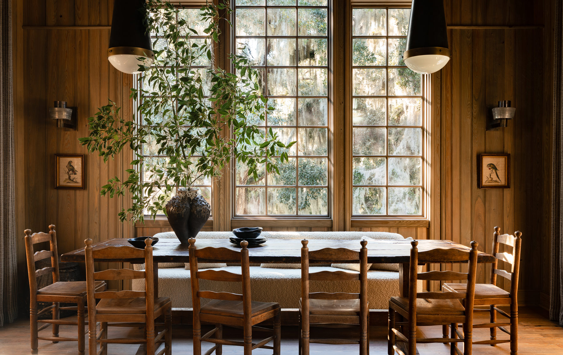 Dining area in the high-ceilinged barn-like great room of a former agrarian building on South Carolina's Edisto Island reimagined as a vacation home by interior designer Sean Anderson and architect Will Wingfield