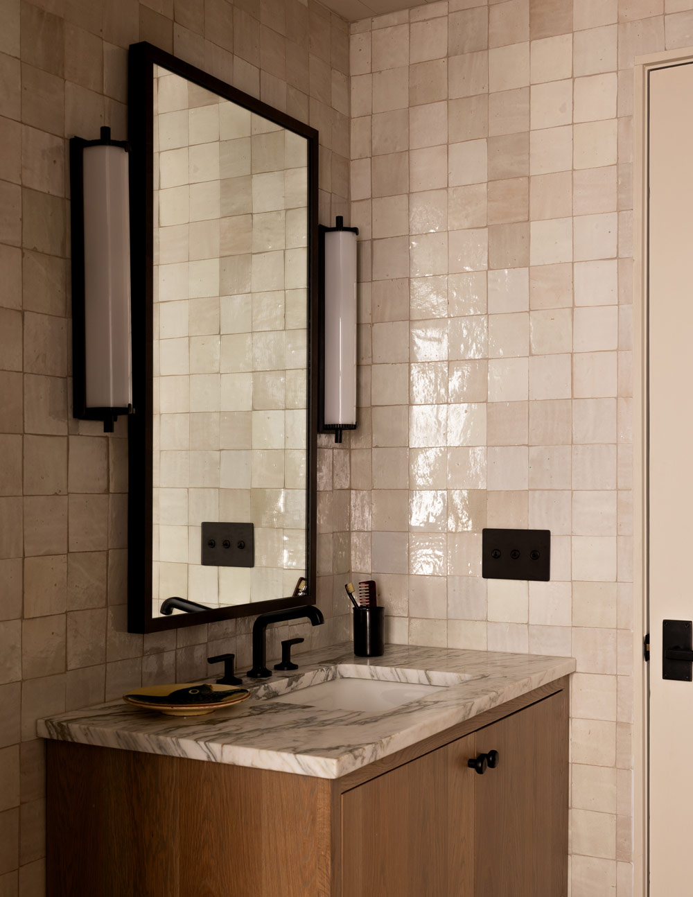 Zellige-tiled powder room in a former agrarian building on South Carolina's Edisto Island reimagined as a vacation home by interior designer Sean Anderson and architect Will Wingfield